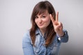 Smiling woman victory gesture with fingers Royalty Free Stock Photo