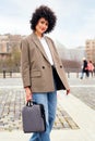 smiling woman walking by the city with briefcase Royalty Free Stock Photo