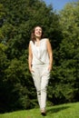 Smiling woman walking in the park Royalty Free Stock Photo