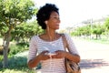 Smiling woman walking in park with headphones Royalty Free Stock Photo