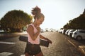 Smiling woman walking to her yoga class listening to music Royalty Free Stock Photo