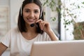 Smiling woman wear headset, watch webinar study, work on laptop, young student in headphones learning computer course Royalty Free Stock Photo