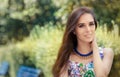 Smiling Woman Wearing Floral Dress and Big Necklace