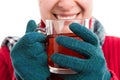 Smiling woman wearing gloves and holding hot tea Royalty Free Stock Photo