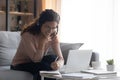 Smiling woman wearing headphones writing notes, studying online Royalty Free Stock Photo