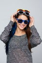 Smiling woman wearing many colourful sunglasses