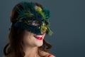 Woman wearing masquerade mask against black background Royalty Free Stock Photo