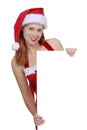 Smiling woman wearing Santa hat holding plain white blank advertisement board Royalty Free Stock Photo