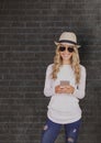 Smiling woman wearing sunhat and sunglasses while using smart phone Royalty Free Stock Photo