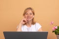 Smiling woman wearing wireless headphones working typing on notebook sit at desk in office workplace. Enjoy e-learning