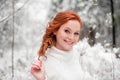 Smiling woman in white sweater in snowy forest Royalty Free Stock Photo