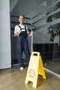 smiling woman with window wiper holding Royalty Free Stock Photo