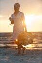 Smiling woman with wine glass on the beach at sunset Royalty Free Stock Photo