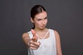 Smiling woman wink and pointing to camera