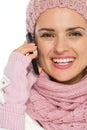 Smiling woman in winter clothing speaking mobile Royalty Free Stock Photo