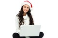 Smiling woman witted on floor using laptop