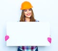 Smiling woman worker builder hold big sign board Royalty Free Stock Photo