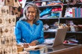 Smiling woman working at the counter of her fabric shop Royalty Free Stock Photo