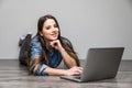 Smiling woman working on laptop on floor Royalty Free Stock Photo