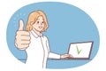 Smiling woman working on laptop showing thumb up Royalty Free Stock Photo