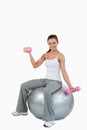 A smiling woman working out with dumbbells Royalty Free Stock Photo