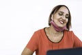 Smiling woman 40 years old wearing open protective face mask using laptop during the end of coronavirus outbreak - Female Royalty Free Stock Photo