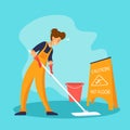 Smiling woman in yellow suit cleaning the floor with a mop. Professional worker of cleaning service Royalty Free Stock Photo