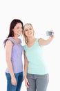 Smiling women with a camera Royalty Free Stock Photo