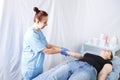 Smiling woman doctor doing a woman`s massage of the woman`s right hand Royalty Free Stock Photo