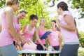 Smiling women organising event for breast cancer awareness Royalty Free Stock Photo