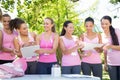 Smiling women organising event for breast cancer awareness Royalty Free Stock Photo