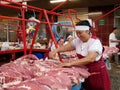 Smiling women working in the meat section of a bazaar in Kazakhstan