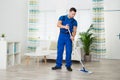 Smiling Worker Cleaning Floor With Mop At Home Royalty Free Stock Photo