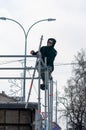 A smiling worker mounts a street stage for a holiday concert