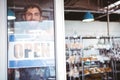 Smiling worker putting up open sign Royalty Free Stock Photo