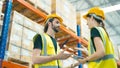 Smiling workers in distribution warehouse having a cheerful conversation Royalty Free Stock Photo