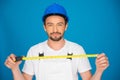 Smiling workman holding a tape measure Royalty Free Stock Photo