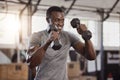 Smiling young african american athlete lifting dumbbells during arm workout in gym. Strong, fit, active happy black man Royalty Free Stock Photo