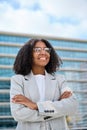 Smiling young African American business woman standing in city looking away. Royalty Free Stock Photo