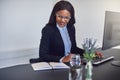 Smiling African American businesswoman working at her office des Royalty Free Stock Photo