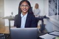 Smiling young African American businesswoman working in an offic Royalty Free Stock Photo