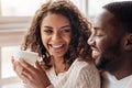 Smiling young African American couple drinking tea in the cafe Royalty Free Stock Photo