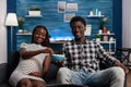 Smiling young african american couple sharing a bowl of popcorn Royalty Free Stock Photo