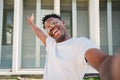 smiling young african american guy african american college student looking at camera and taking a selfie with his Royalty Free Stock Photo