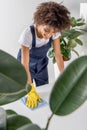 smiling young african american housekeeper wiping table Royalty Free Stock Photo