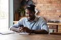 Smiling young african american man using mobile phone. Royalty Free Stock Photo