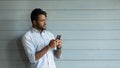 Smiling young african american man using mobile phone. Royalty Free Stock Photo