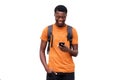 Smiling young african american man looking at cellphone against isolated white background Royalty Free Stock Photo