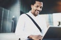 Smiling young African American man sending email via electronic touch pad pro holding in hands.Concept of guy using Royalty Free Stock Photo