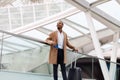 Smiling Young African American Man Standing With Suitcase At Airport Royalty Free Stock Photo